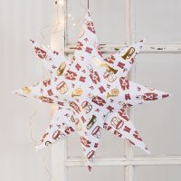 Stor julestjerne foldet i designpapir med nøddeknækker motiv